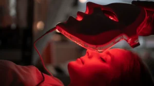 Woman receiving red light therapy on her face