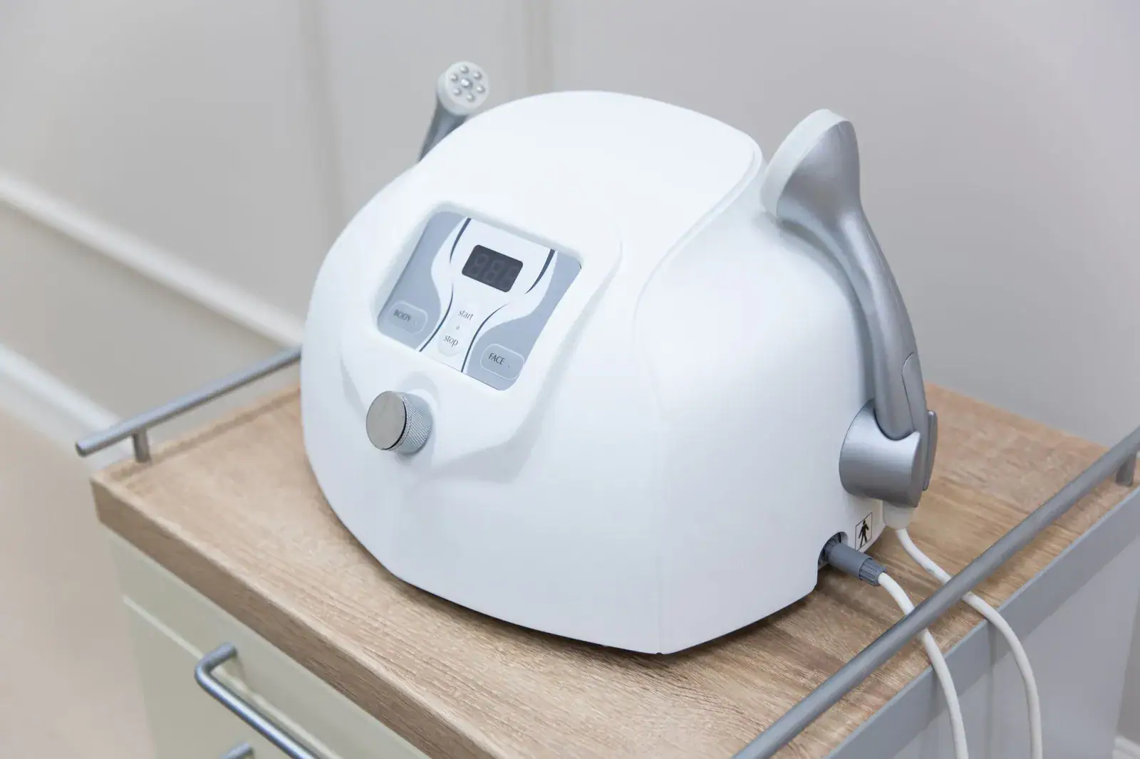 A clinic skin treatment device on a trolley in a treatment room